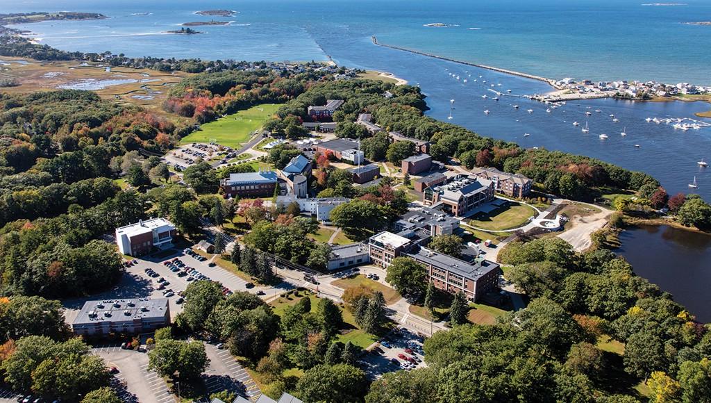 Aerial photo of U N E's Biddeford campus including buildings and the ocean